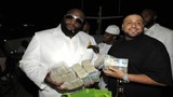 rick-ross-with-money-stacks